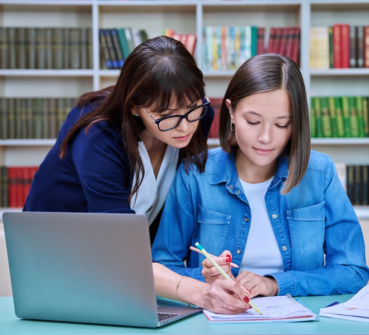 Teacher assisting student with homework